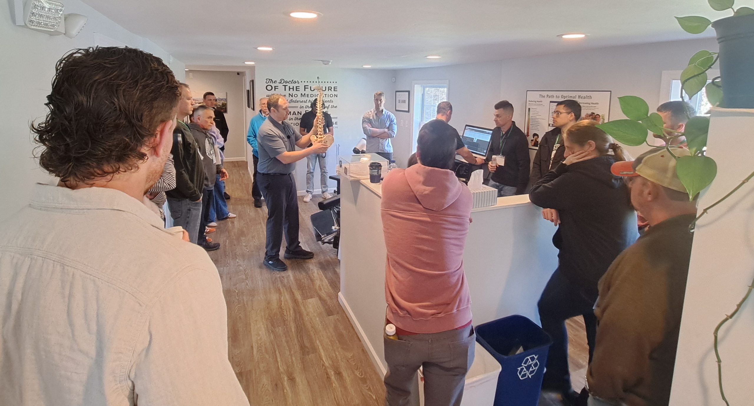 Group of Chiropractors discussing spinal care at an adjusting table